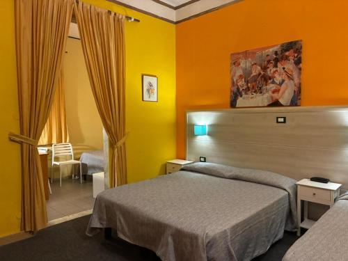 Postel nebo postele na pokoji v ubytování Hotel Annunziata