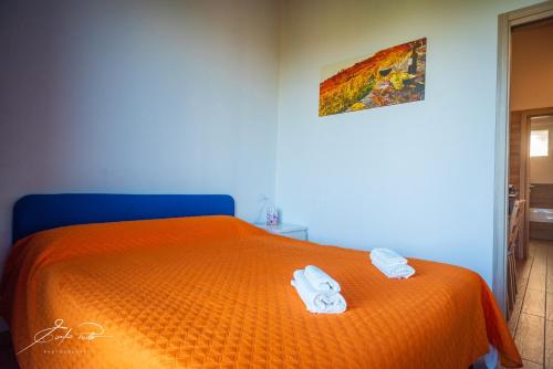 Ένα ή περισσότερα κρεβάτια σε δωμάτιο στο Casa Vacanze Elios