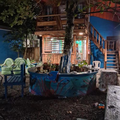 a tree in a tub in front of a house at enjoy the nature of the countryside in Bonao