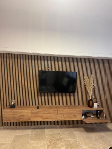 - une télévision à écran plat sur un mur en bois dans l'établissement Magnifique 2 pièces en plein centre de Cannes à côté des plages, à Cannes