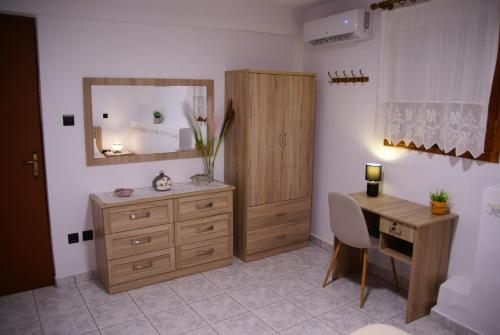 a bathroom with a desk and a dresser and a mirror at Socros Home, Mesta Chios in Mestá