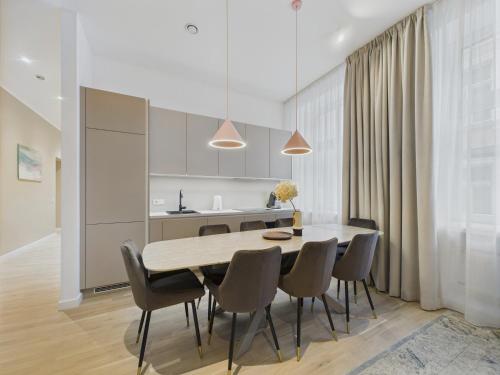 a kitchen and dining room with a table and chairs at K1820 Family apartments in Rīga