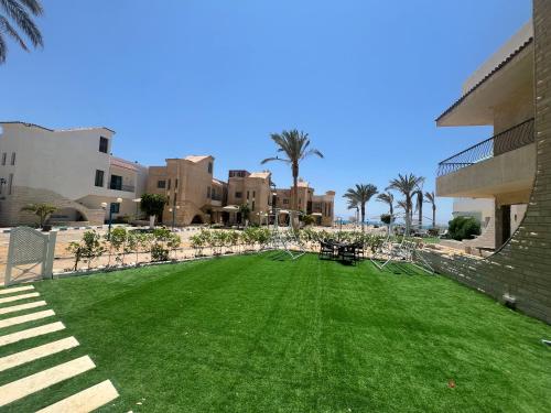 a large lawn in front of a building at Beach Villa in Ras Sidr at Red Sea in Ras Sedr
