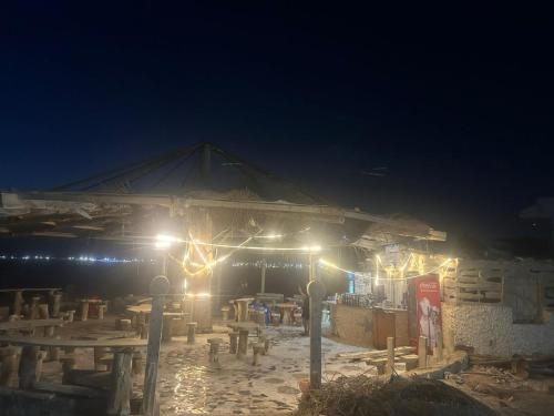 a tent with lights in front of it at night at Beach Villa in Ras Sidr at Red Sea in Ras Sedr