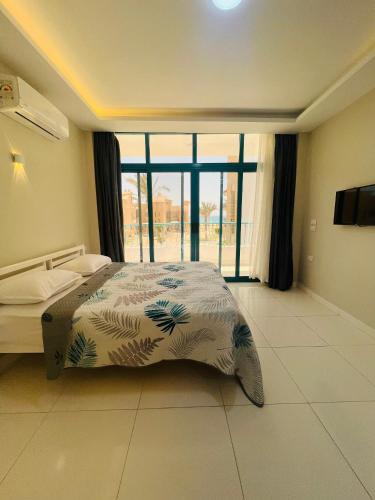 a bedroom with a bed and a large window at Beach Villa in Ras Sidr at Red Sea in Ras Sedr