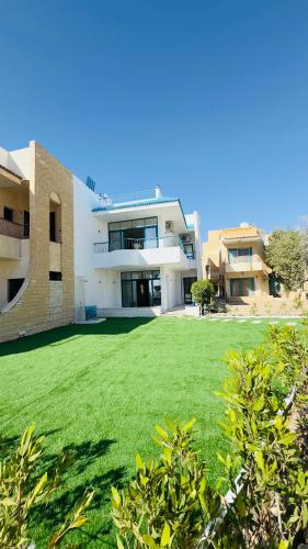 a large yard in front of a large building at Beach Villa in Ras Sidr at Red Sea in Ras Sedr