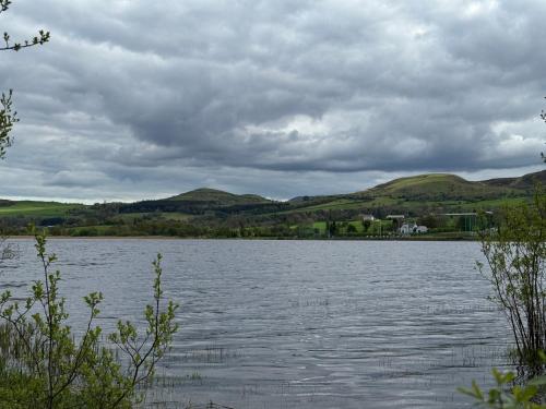 a large body of water with mountains in the background at Rusty Cottage with View in Blacklion