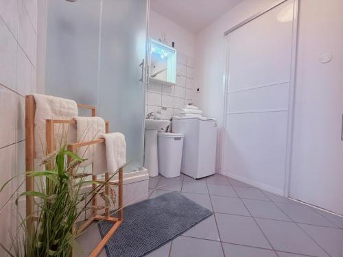 a white bathroom with a shower and a toilet at House Rukavina in Bakarac