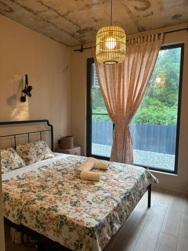 a bedroom with a bed and a large window at The Best House in Ureki