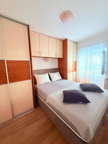 a bedroom with a large bed with pillows on it at House Rukavina in Bakarac
