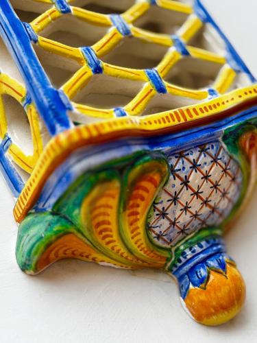 a colorful vase sitting on top of a table at Syrene Suites Sorrento in Piano di Sorrento