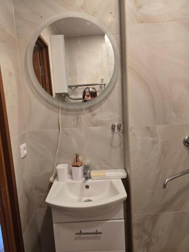 a bathroom with a sink and a mirror at Apartaments Kaunas in Kaunas
