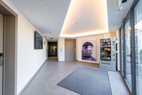 a hallway of a store with a large window at Attica Résidences, Lausanne in Saint-Sulpice