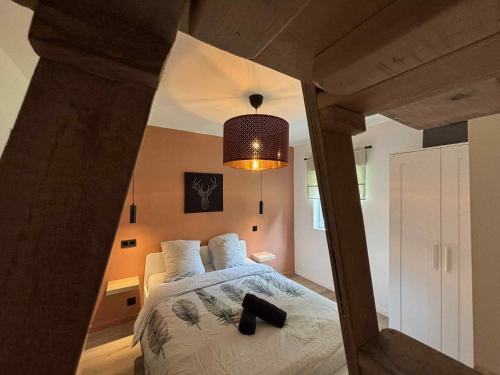 a bedroom with a large bed with a black object on it at Les hauts de Barvaux in Durbuy