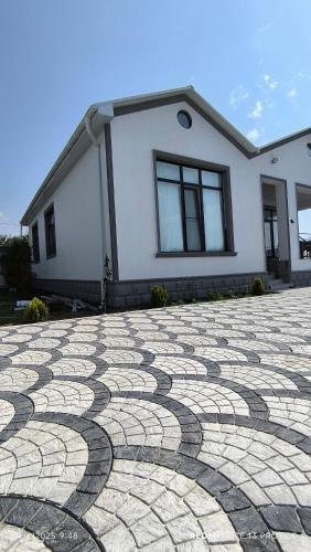 a house with a stone driveway in front of a house at White House gabala 
