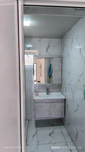 a bathroom with a sink and a mirror at White House gabala 