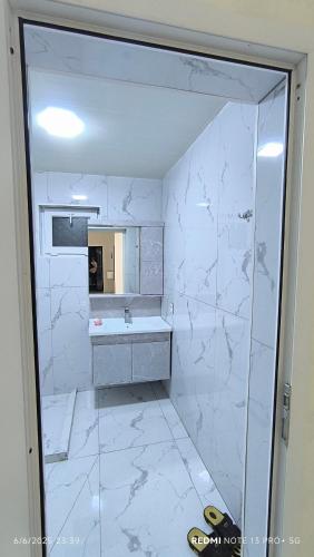 a white bathroom with a sink and a mirror at White House gabala 