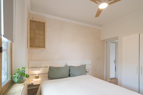 une chambre avec un lit blanc et une fenêtre dans l'établissement Appartement Villa Toki-Ona, à Antibes