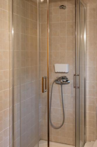a shower with a glass door in a bathroom at Casa da Janeira in Vieira do Minho