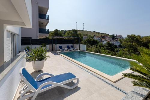 a swimming pool on the balcony of a house at Villa Mare in Klek