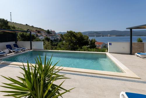 a swimming pool with a view of the water at Villa Mare in Klek