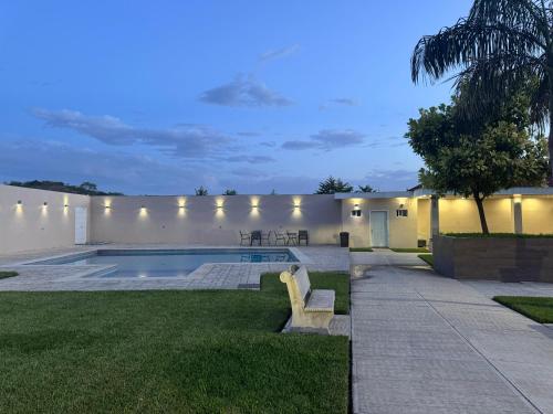 a backyard with a swimming pool and a house at Anturios House Apartamento 2 in San Marcos
