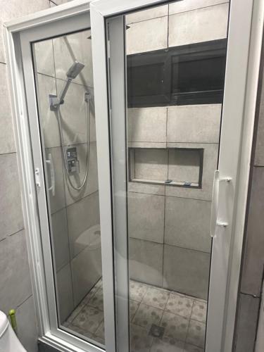 a glass shower door in a bathroom at Anturios House Apartamento 2 in San Marcos