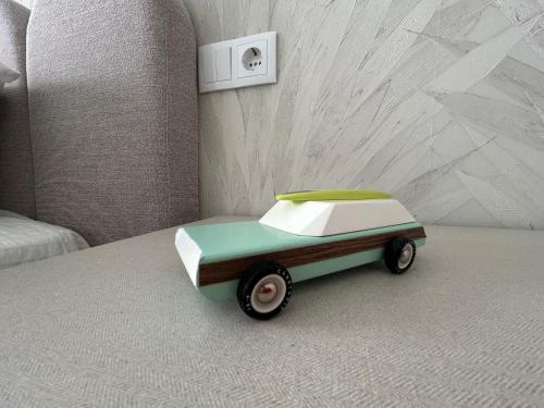 a toy car sitting on top of a bed at Dania Home Noia in Noya
