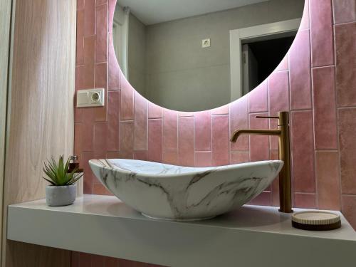 a bathroom with a marble sink and a mirror at Dania Home Noia in Noya
