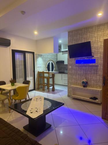 a living room with a table and a fireplace at Hotel MARIN in Oran