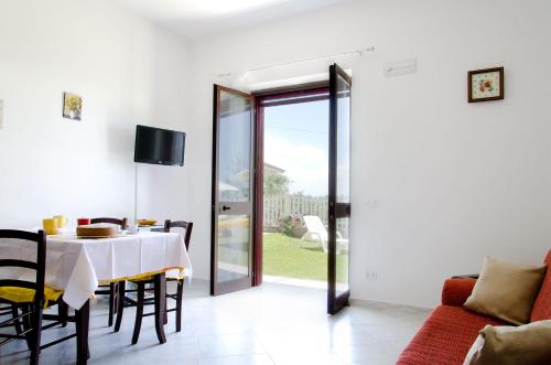 a dining room with a table and a couch at Casa Campanina in Agropoli
