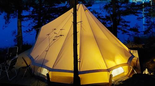 a large white tent with a light on it at Sälstationen - The seal station 