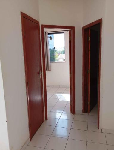 an empty room with two doors and a window at Apartamento 02 Quartos São João de Jequié in Jequié