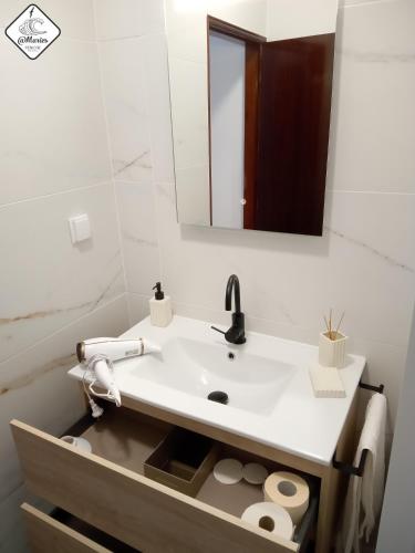 a white bathroom with a sink and a mirror at At Maries Beach House Peniche 2 in Peniche