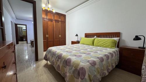 a bedroom with a bed with a green pillow at CASA ENTERA PLAYA PUERTO del ROSARIO in Puerto del Rosario