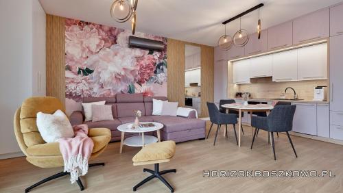 a living room with a couch and a table at Boszkowo Horizon Park Apartament 27 "Romantic" in Boszkowo