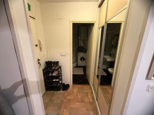 a hallway with a mirror and a bathroom at Alipasha's Apartment in Sarajevo