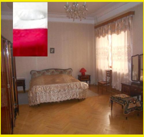 a bedroom with a bed and a chandelier at Guli in Gori
