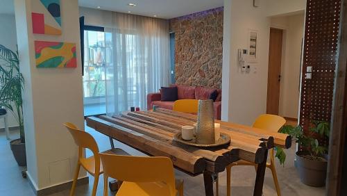 a living room with a wooden table and chairs at "Naias"seaside residence in the port of Piraeus-entire holiday home in Piraeus