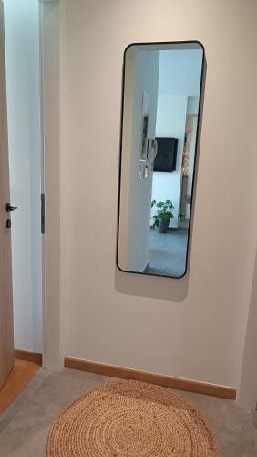 a mirror on a wall in a room with a rug at "Naias"seaside residence in the port of Piraeus-entire holiday home in Piraeus