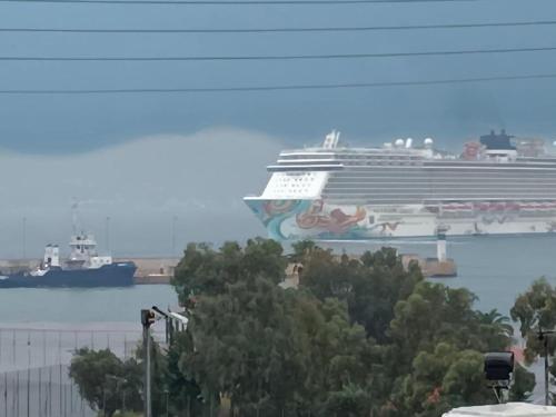 a cruise ship is docked in a harbor at "Naias"seaside residence in the port of Piraeus-entire holiday home in Piraeus