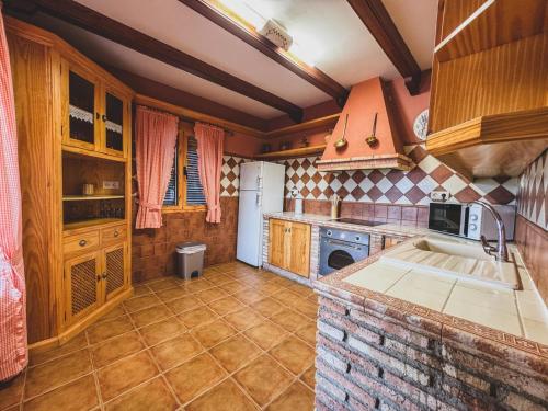 a kitchen with a sink and a stove top oven at Mirador de Despeñaperros in Santa Elena