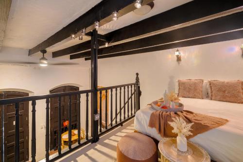 a room with a balcony with a bed and a table at The Dream of Old San Juan by PH in San Juan