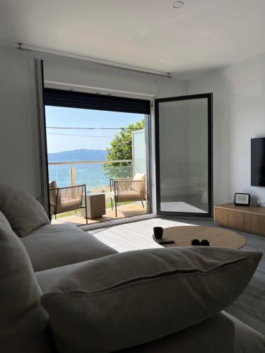 a living room with a couch and a view of the ocean at Piso Sinas con vistas al mar in Villanueva de Arosa