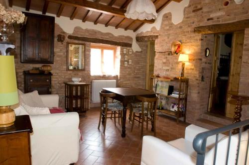 a kitchen and living room with a table and chairs at B&B La Cappellania in Montegiorgio