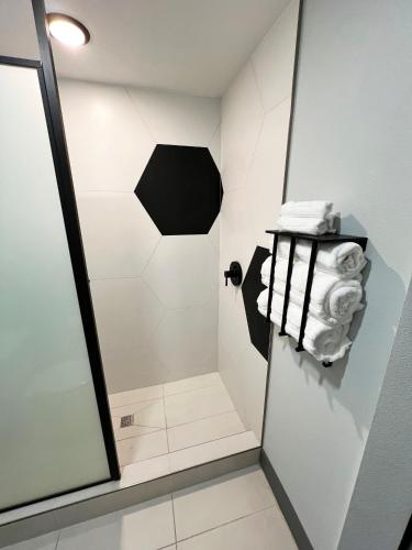a bathroom with a shower with towels in it at Bent Inn - LGBTQ Hotel in Las Vegas