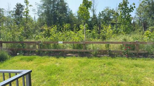 a wooden fence in a field of grass at Basement suite -Langley Willoughby in Langley