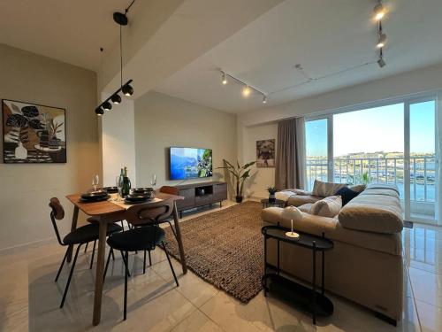 a living room with a couch and a table at Valletta and Sea Views Super Location in Il-Gżira