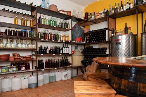a bar with a table and many bottles of wine at Vržina Farm House Skadar Lake in Virpazar
