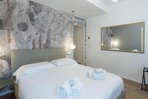 a bedroom with a white bed with towels on it at Maison Rasella Palace Suites in Rome